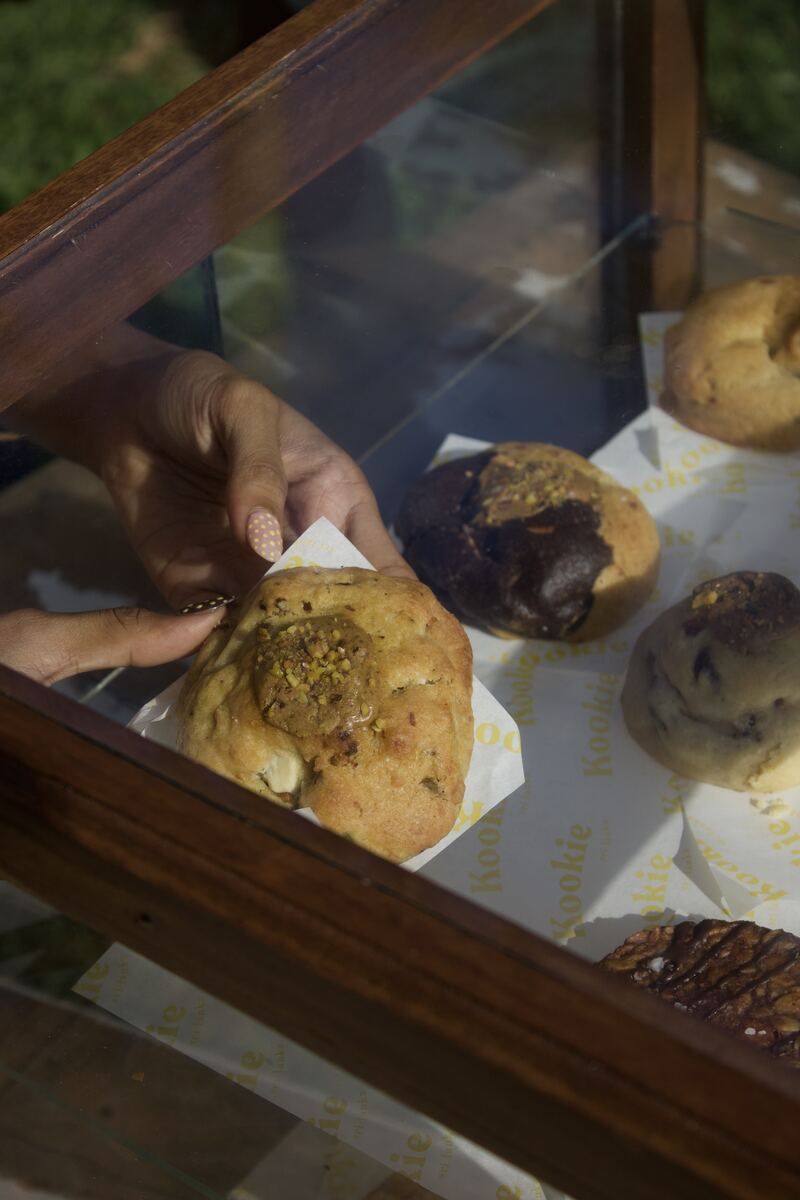 Reaching into the display case for a Kookie cookie