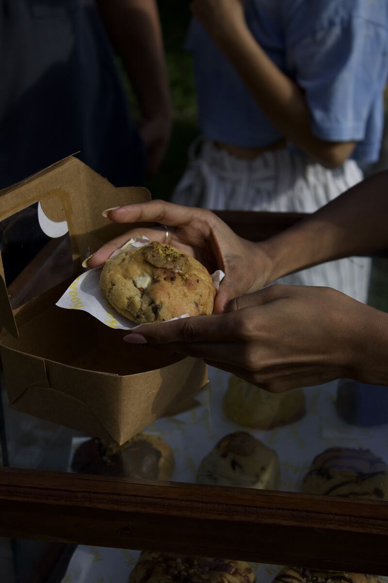 Holding a Kookie pistachio cookie from a takeaway box